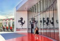 Maranello, Italy Ã¢â¬â July 26, 2017: Girl near main entrance to famous, popular Ferrari museum (Enzo Ferrari).